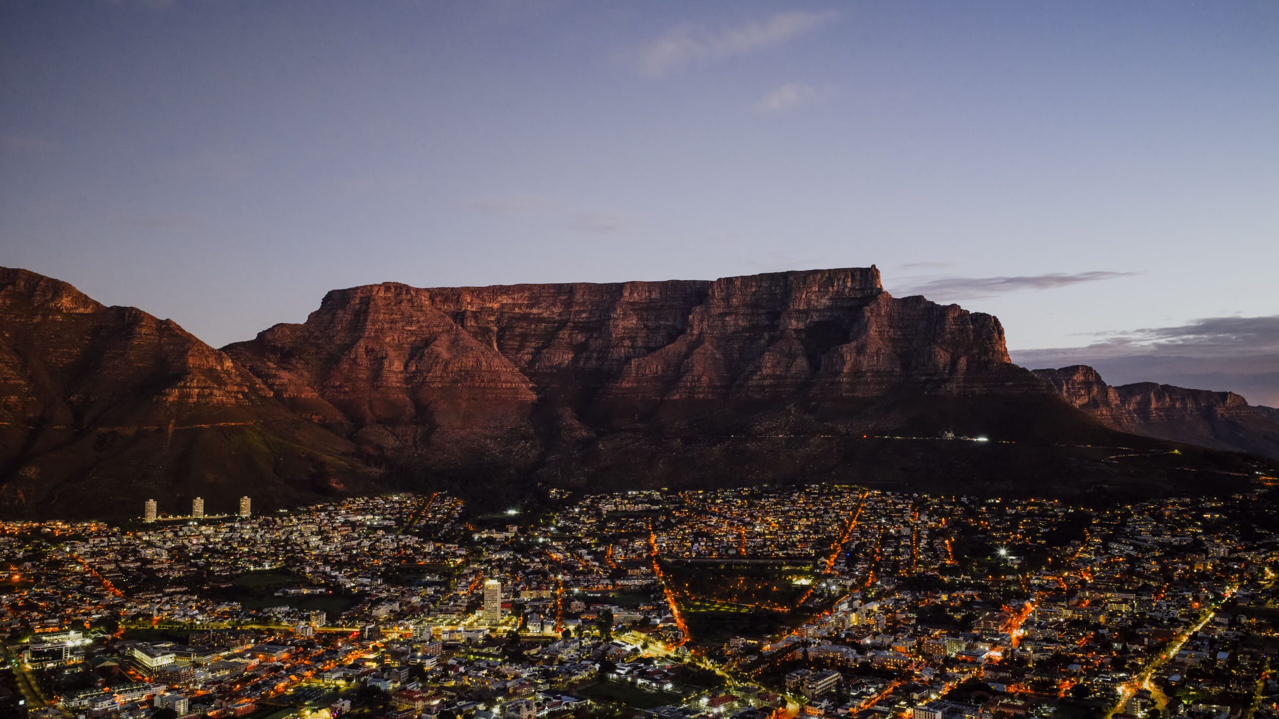 Table Mountain above the lights of Cape Town at dusk